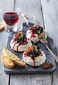 Baked camembert cheese with blackberry topping