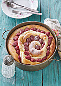 Spiral cake with custard and raspberries