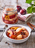 Pear compote with red plums, orange rind and spice