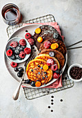 Pancakes with berries, physalis and maple syrup