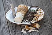 Horseradish root, partly peeled and grated
