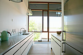 Kitchen with glass wall in loft apartment