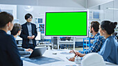 Engineer using a green screen in a factory meeting