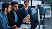 Team of industrial engineers working on computer