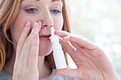 Woman using a nasal spray