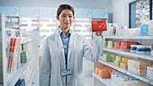 Pharmacist holding a box of pills