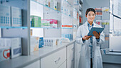 Pharmacist using a digital tablet in a pharmacy
