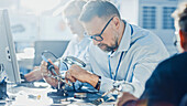 Electronics development engineers working on computers