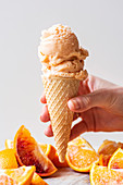 Homemade orange sherbet in ice cream cone