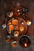Christmas arrangement of gilt candlesticks and baking tins