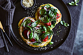 Vegan potato flatbreads with baked tomatoes and basil