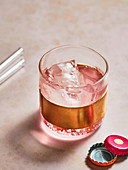 Pink rose drink with ice cubes