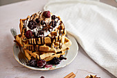 Waffles with sweet cream, fresh berries and melted dark chocolate