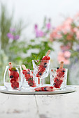 Homemade sorbet ice pops with berries in glasses
