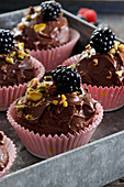 Chocolate muffins with pistachios and blackberries