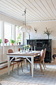 Dining area in front of a window, with a piano in the background