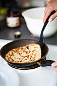 Making pancakes on frying pan