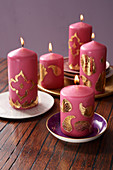 Indian candle arrangement: pink candles decorated with golden wax