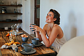 Smiling woman at breakfast table