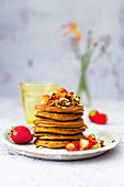 Sweet potato pancakes with crunchy muesli, honey and strawberries (gluten-free)
