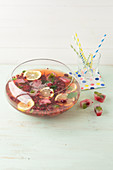 Raspberry tea punch with mineral water, berries and lemon
