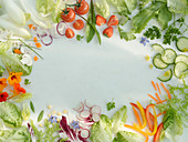Romaine lettuce and various salad ingredients grouped around the edge of the picture