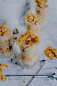 Layered desserts with biscuit, caramel and almonds
