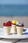 Currants, yellow watermelon, and dragon fruit, served in ice cream cones