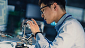 Electronics engineer soldering a circuit board