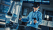 Engineer controlling a robotic arm using virtual reality