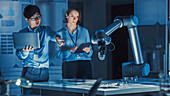 Engineers analysing a robotic arm