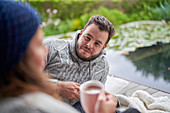 Man listening to wife on patio