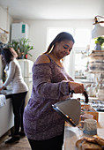 Woman preparing tea in kitchen