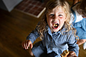 Girl showing food in mouth