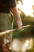 Man holding fly fishing pole