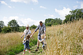 Happy family running in a sunny rural field