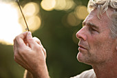 Man inspecting fishing pole line