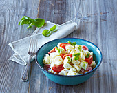 Pasta salad with tomatoes, mozzarella and basil