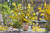 Easter bouquet made of flowering branches of forsythia, decorated with Easter eggs