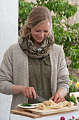 Easter terrace: Woman cuts salmon rolls