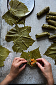 Koupepia with Hands stuffing vine leaves