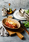 Lasagna Bolognese traditional Italian food on concrete background