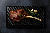 Barbecue grilled Tomahawk Steak on cast iron grill