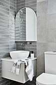 Washstand with countertop sink below mirror