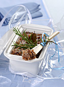 Pork rillettes with a sprig of rosemary