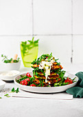 Potato and zucchini hash browns with quark cream and rocket salad