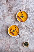 Bowls of Pumpkin Soup with Crispy Bacon and Pumpkin Seeds