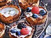 Muffin tin granola cups filled with yogurt and berries