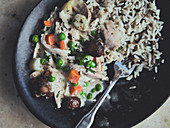 Chicken fricassee with rice in a cast iron pan