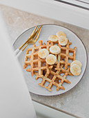 Waffles with banana and maple syrup